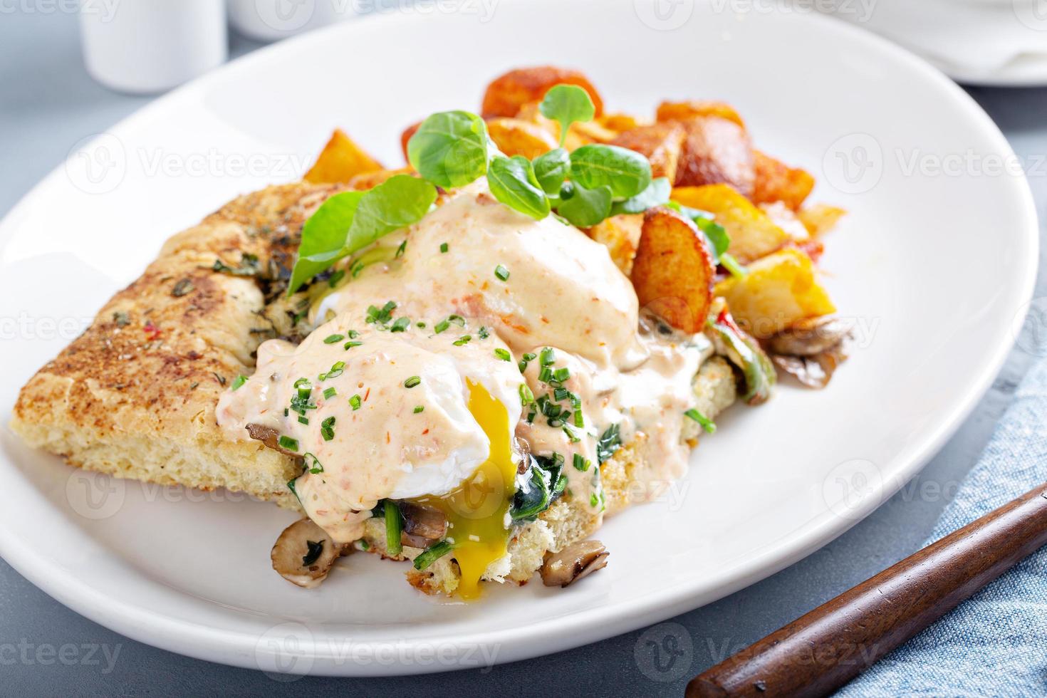 Eggs Benedict with focaccia and potatoes photo