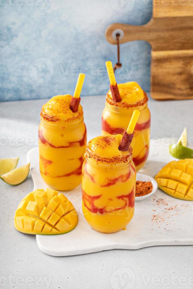 Mangonada mexican mango smoothie with chamoy sauce and lime seasoning photo