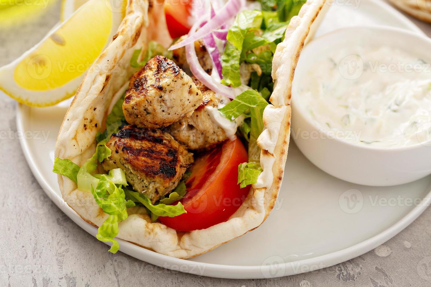 Greek chicken souvlaki on wooden skewers photo