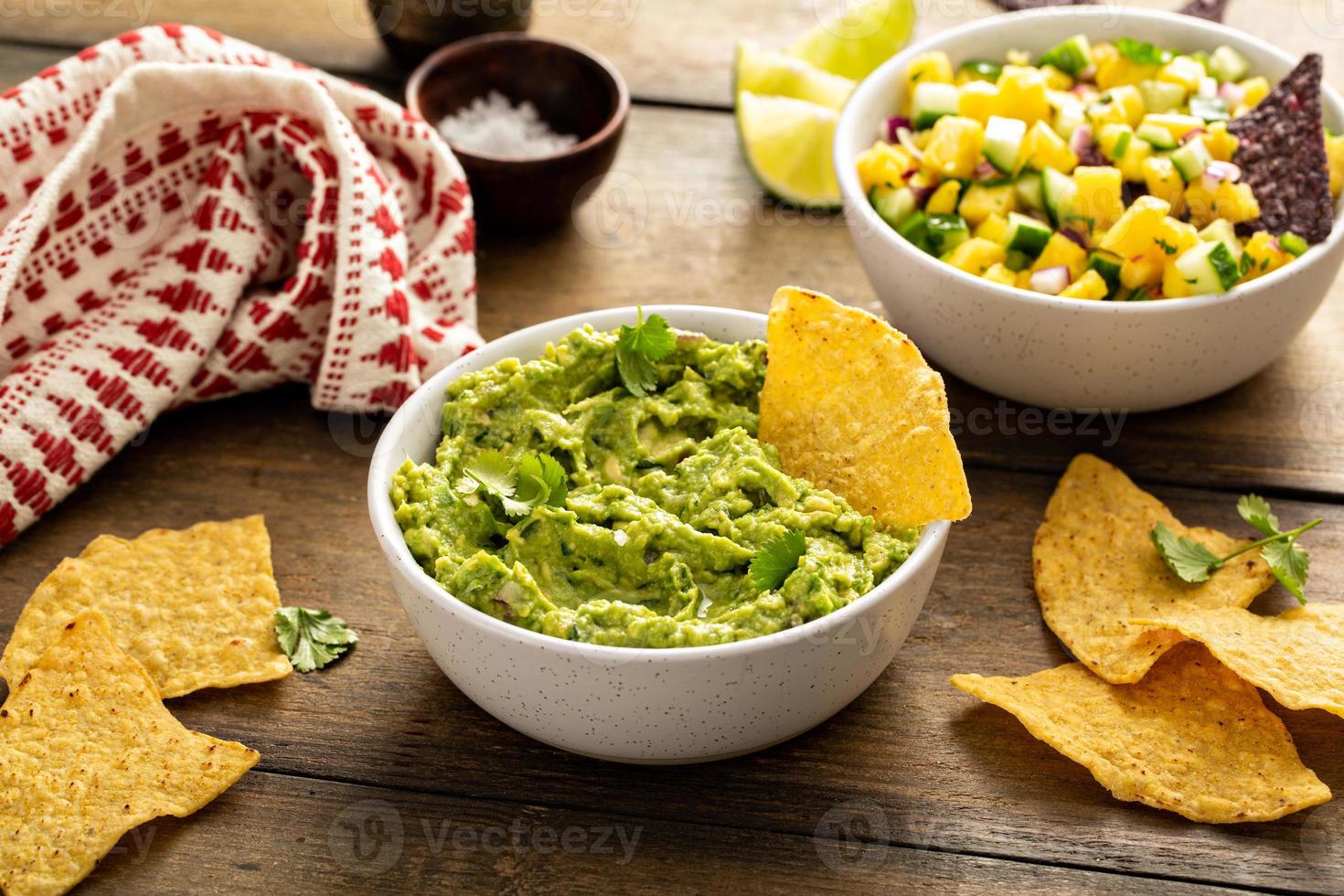 Tortilla chips with dips, guacamole and salsa photo