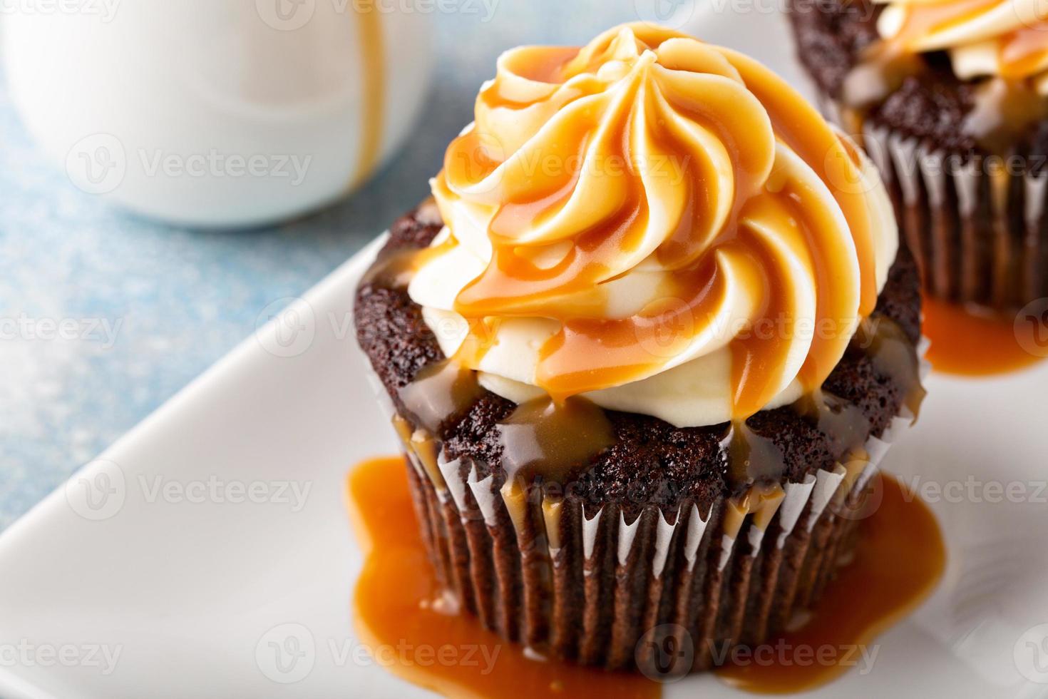 Chocolate cupcake with cream cheese frosting and caramel photo