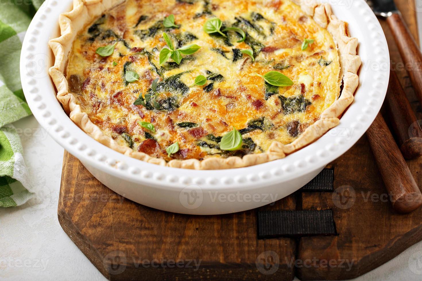 Homemade quiche with bacon and spinach photo