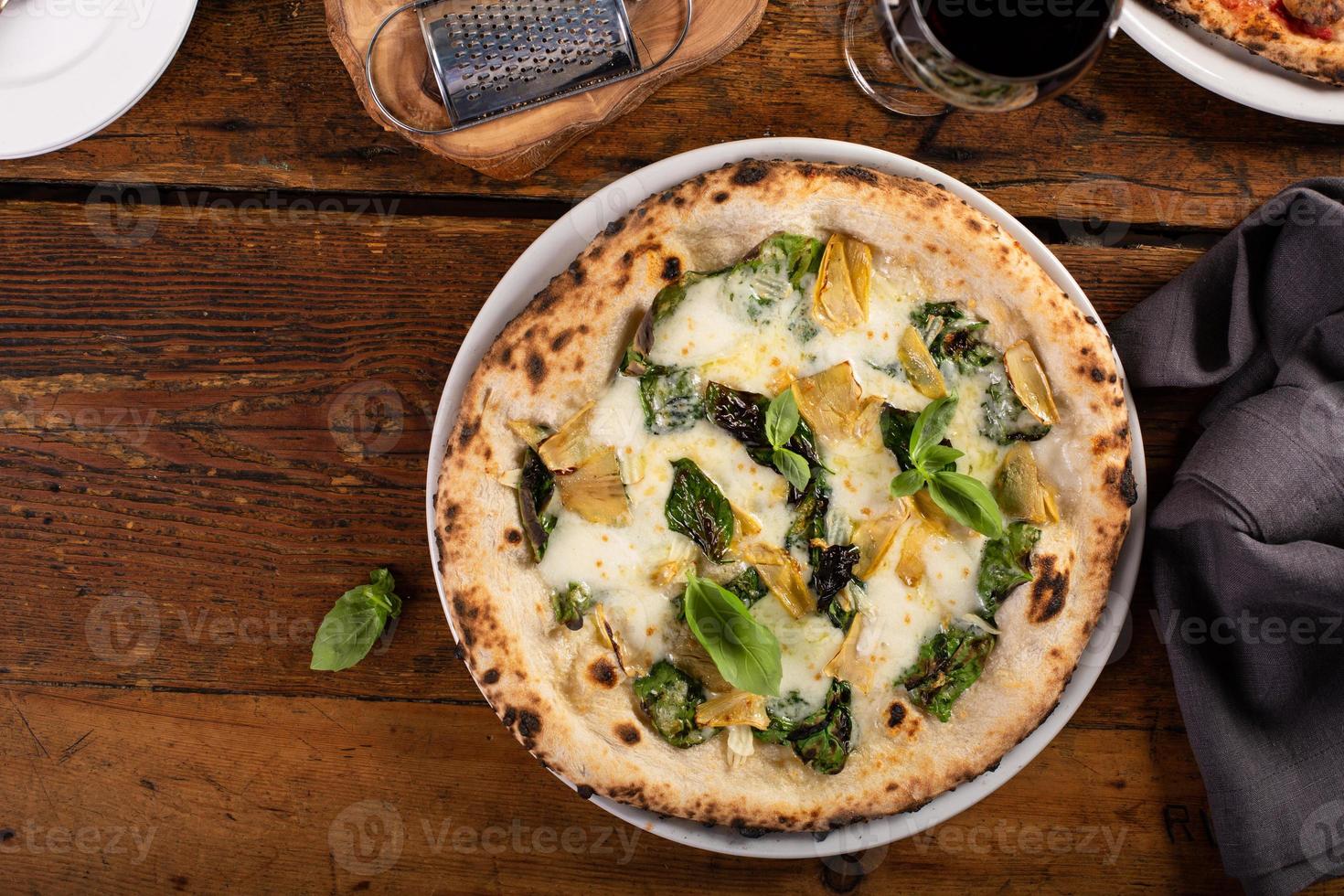 Pizza bianca or white pizza with artichokes and basil photo