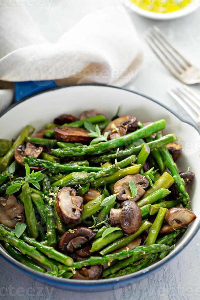 Asparagus and mushrooms in a cast iron pan photo