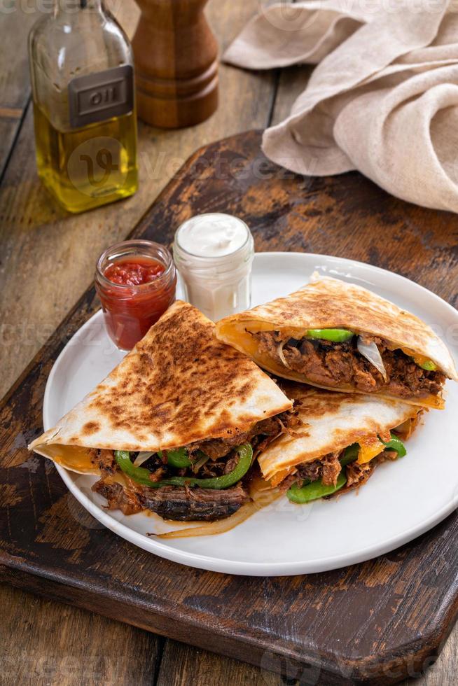 Brisket, peppers and onions quesadillas cut on a plate 16118547 Stock Photo at Vecteezy