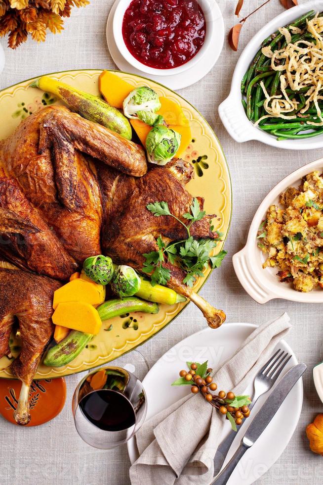 Traditional Thanksgiving table with turkey and sides photo