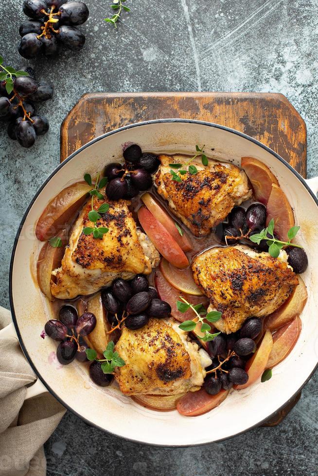 Chicken thighs roasted with grapes and apples photo