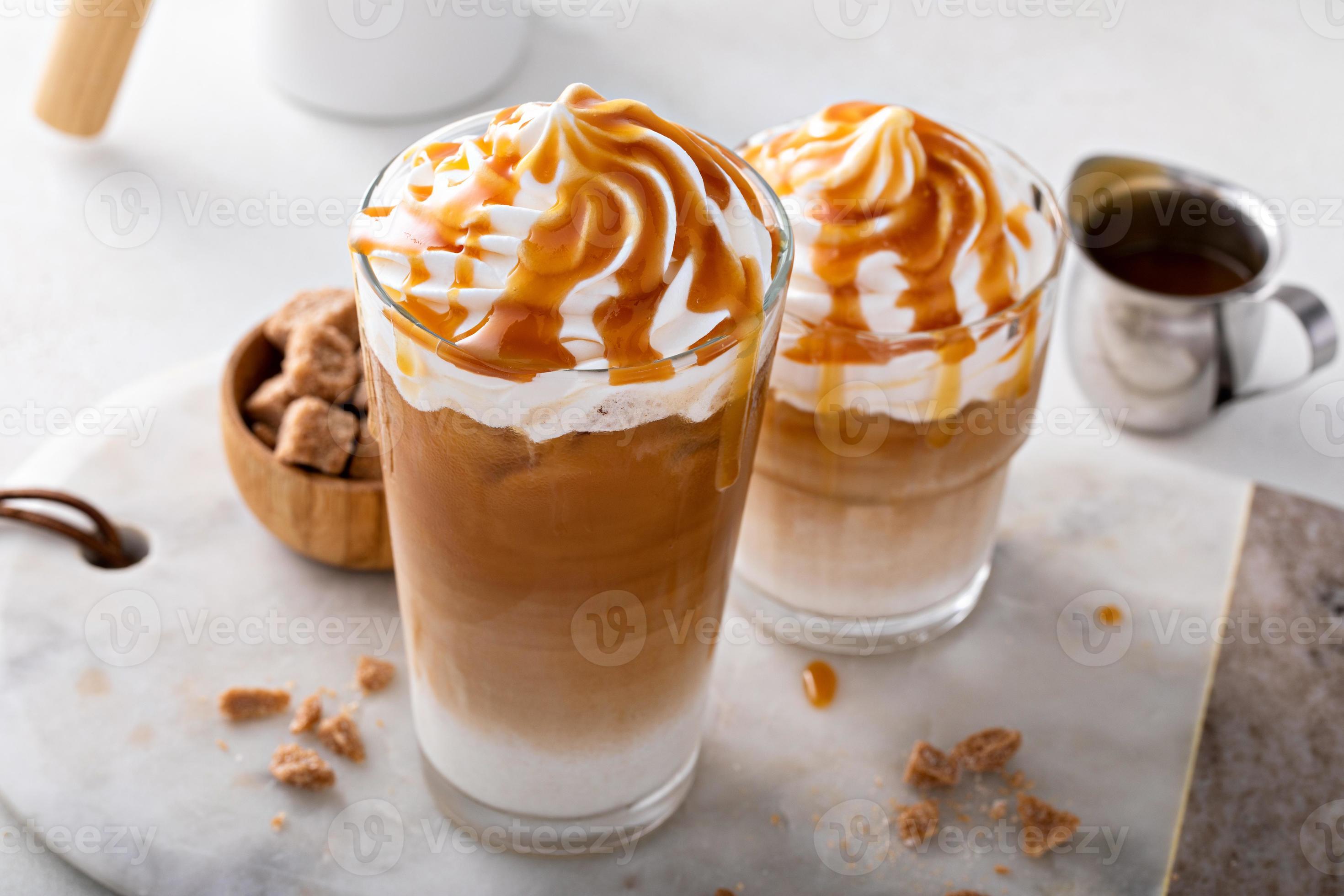 Iced caramel latte topped with whipped cream and caramel sauce 16118830