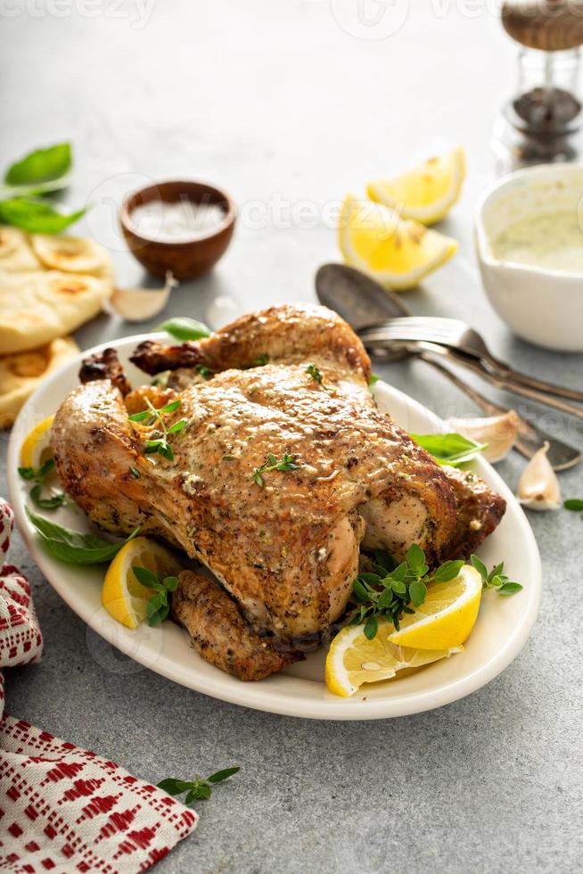 Whole lemon herbs and garlic roasted chicken photo