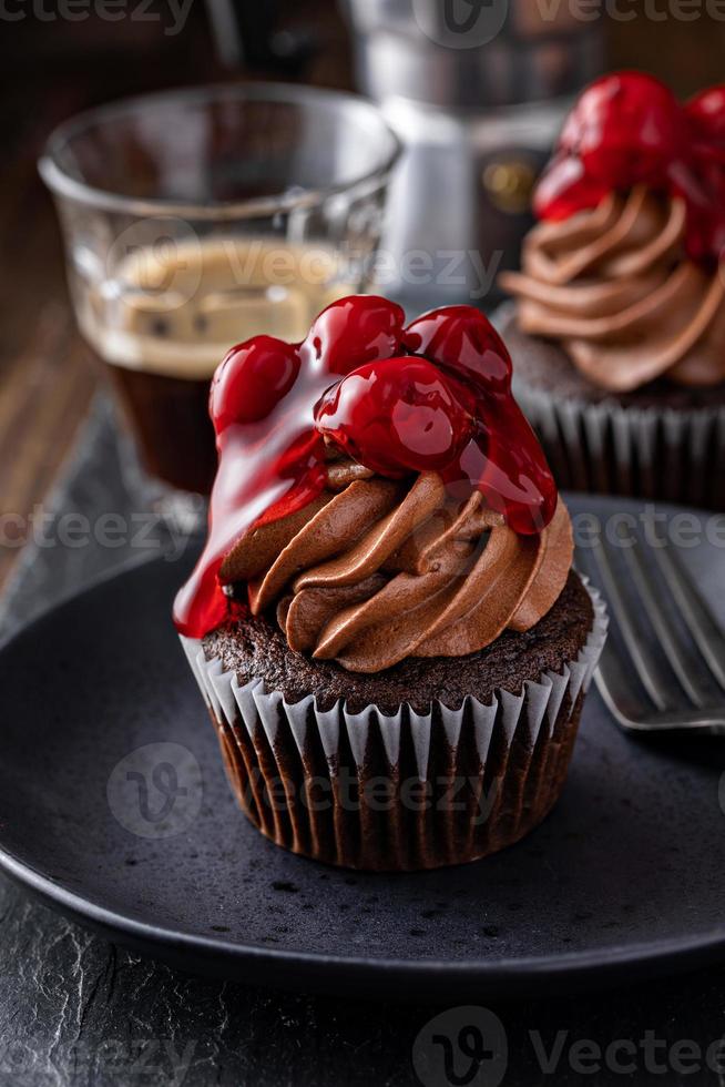 Black forest cupcake with whipped ganache and cherry topping photo