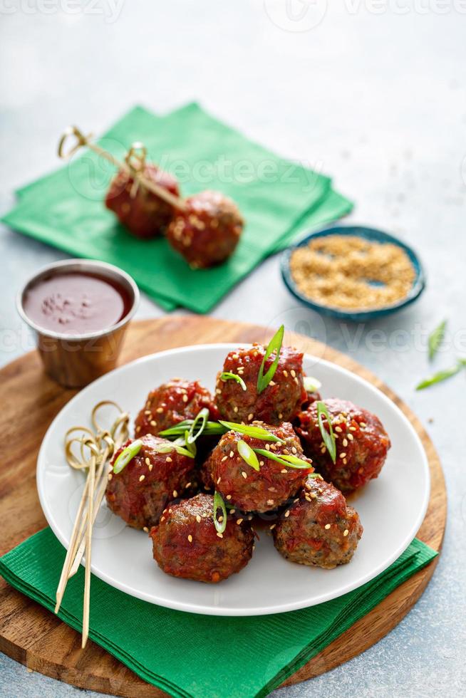 Asian meatballs appetizers with sweet and sour sauce photo