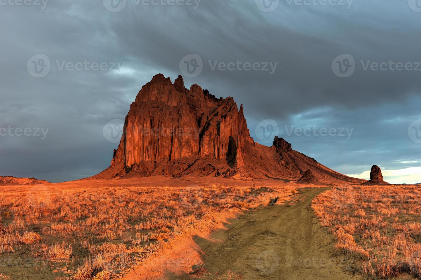 Shiprock is a monadnock rising nearly 1,583 feet above the high-desert plain of the Navajo Nation in San Juan County, New Mexico, United States. photo
