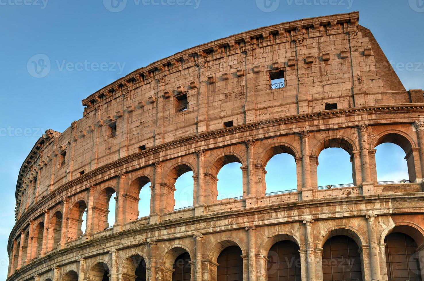 Ancient Roman Colosseum at sunset in Rome, Italy. photo