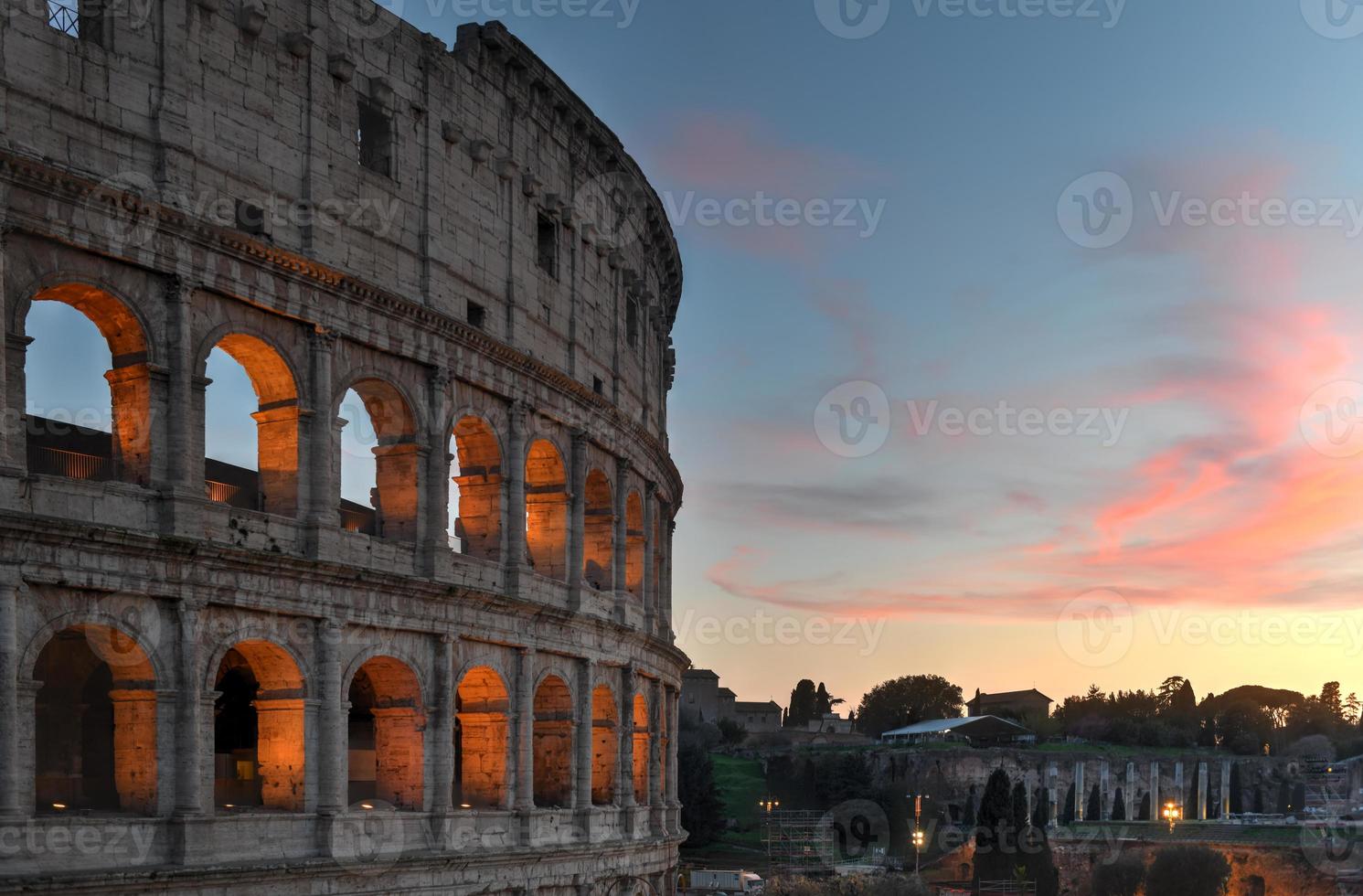 Ancient Roman Colosseum at sunset in Rome, Italy. photo