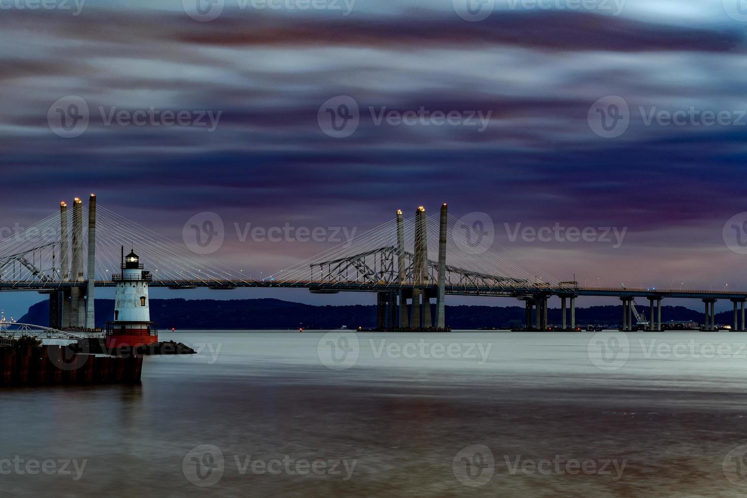 New and Old Tappan Zee Bridges coexisting across Hudson River with a dramatic sunset. photo