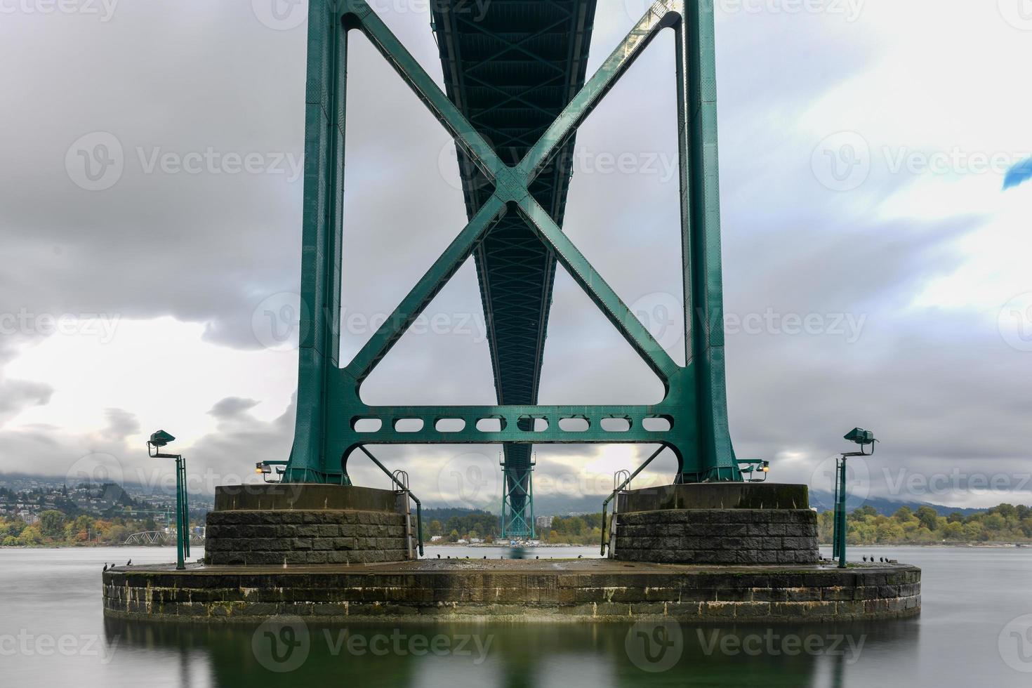 Lions Gate Bridge as seen from Stanley Park in  Vancouver, Canada. The Lions Gate Bridge, opened in 1938, officially known as the First Narrows Bridge, is a suspension bridge. photo