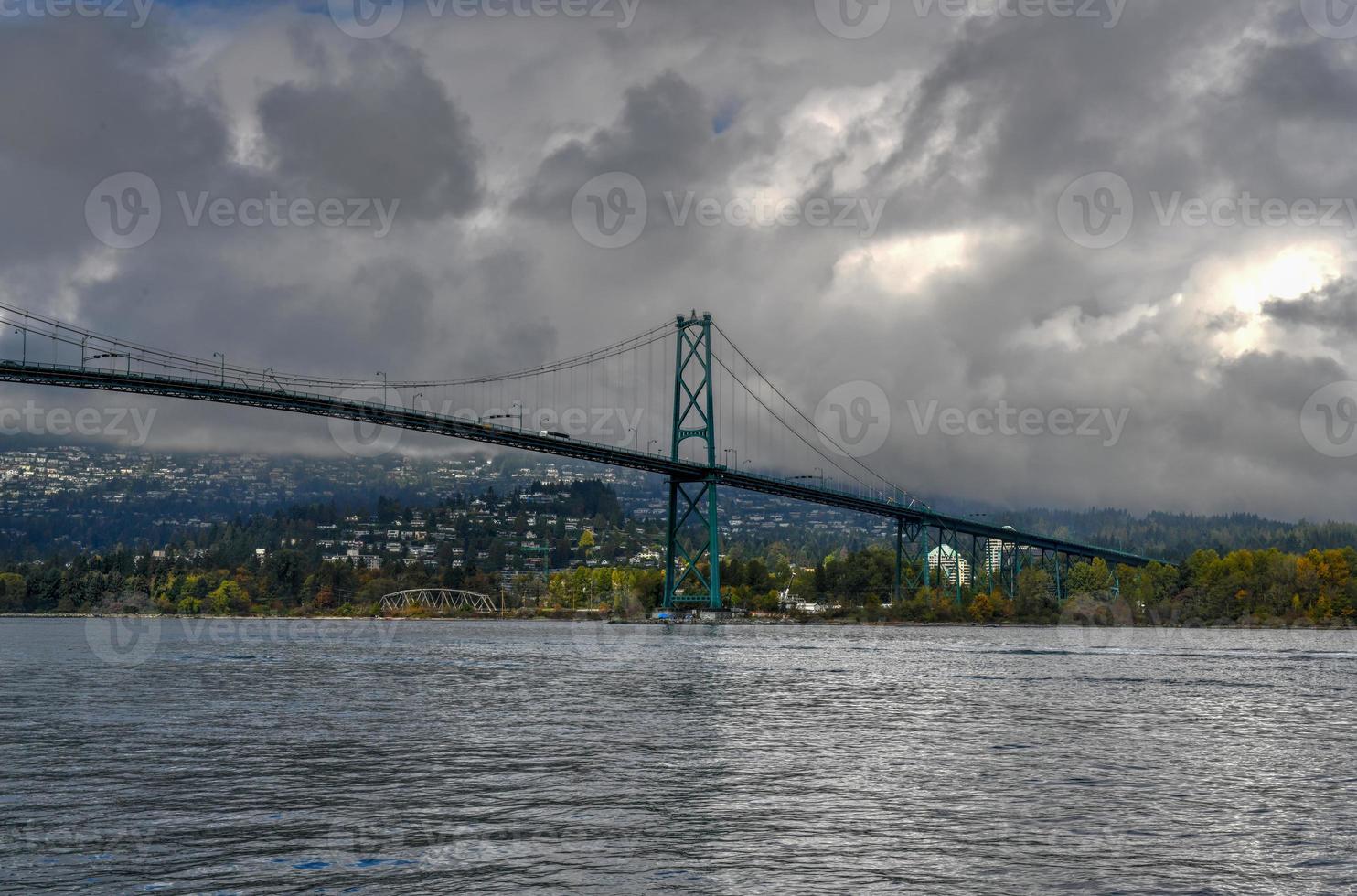 Lions Gate Bridge as seen from Stanley Park in  Vancouver, Canada. The Lions Gate Bridge, opened in 1938, officially known as the First Narrows Bridge, is a suspension bridge. photo