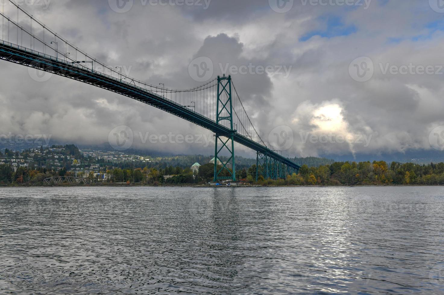 Lions Gate Bridge as seen from Stanley Park in  Vancouver, Canada. The Lions Gate Bridge, opened in 1938, officially known as the First Narrows Bridge, is a suspension bridge. photo