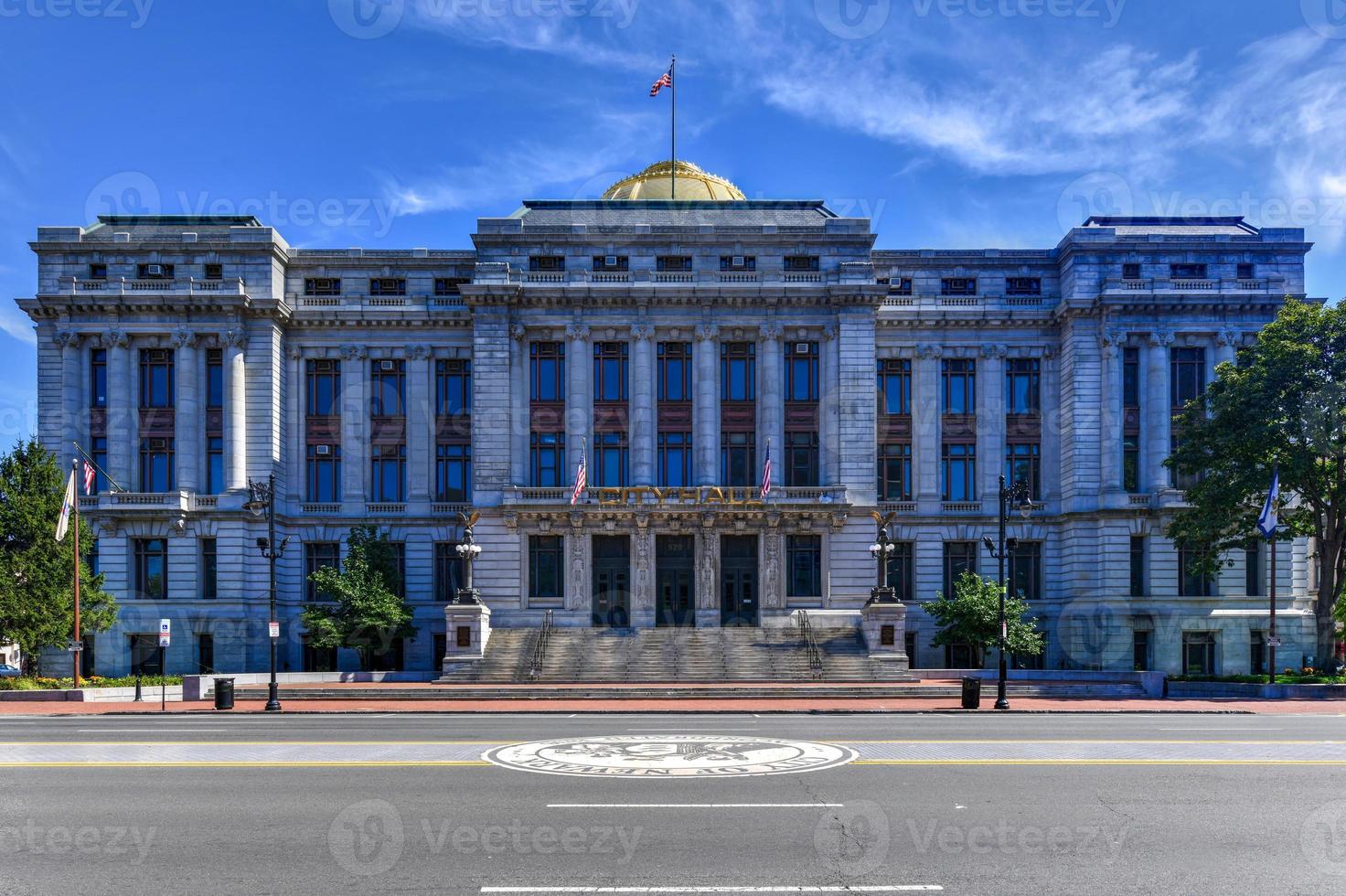 Newark City Hall building. The building is a five-story building with a golden dome photo