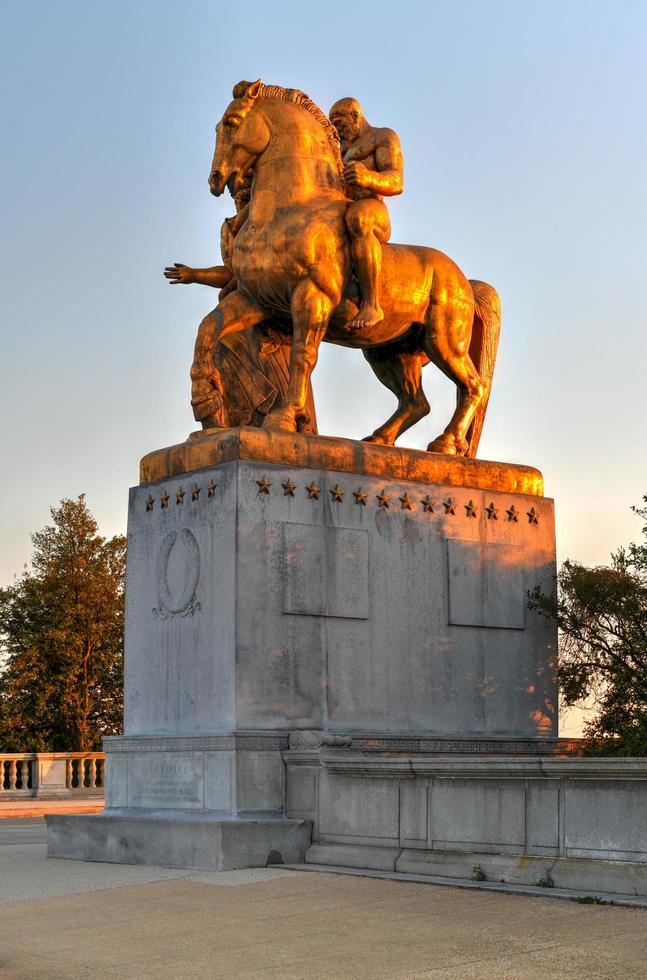 Washington, DC - Apr 4, 2021 -  Arts of War, bronze, fire-gilded statue groups on Lincoln Memorial Circle in West Potomac Park at sunset in Washington, DC photo