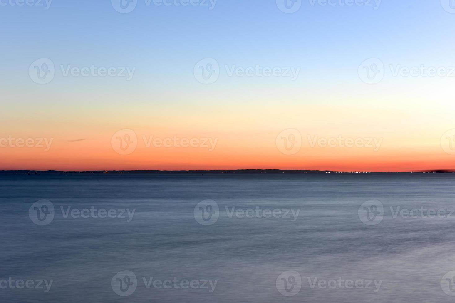 Sunset on the horizon across the Atlantic Ocean. photo