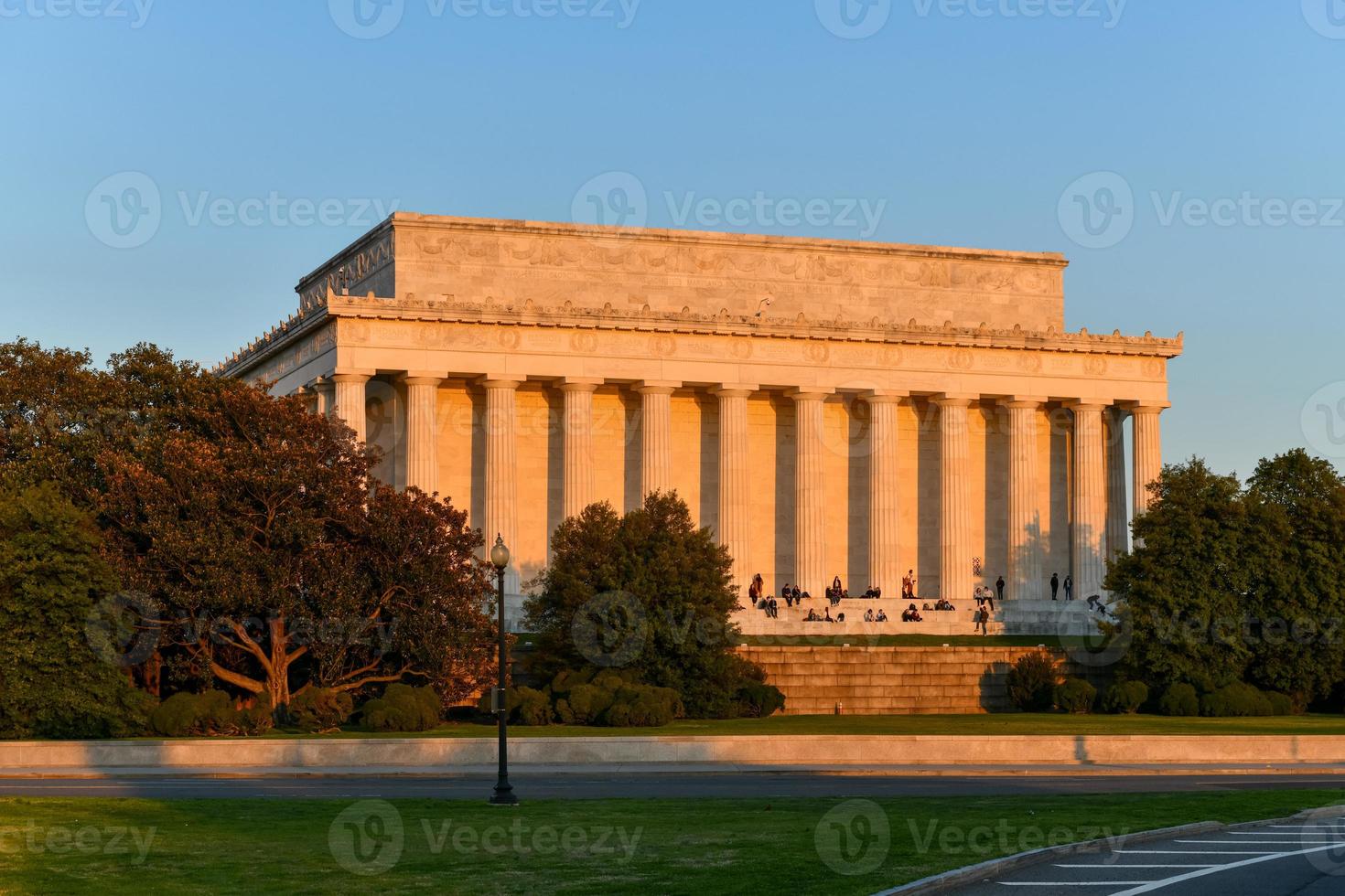 Washington, DC - Apr 3, 2021 -  Lincoln Memorial from the rear with spectators enjoying the sunset in Spring in Washington, DC photo