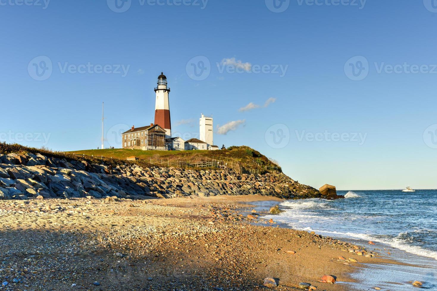The Montauk Point Lighthouse located adjacent to Montauk Point State Park, at the easternmost point of Long Island, in the hamlet of Montauk in the Town of East Hampton in Suffolk County, New York. photo