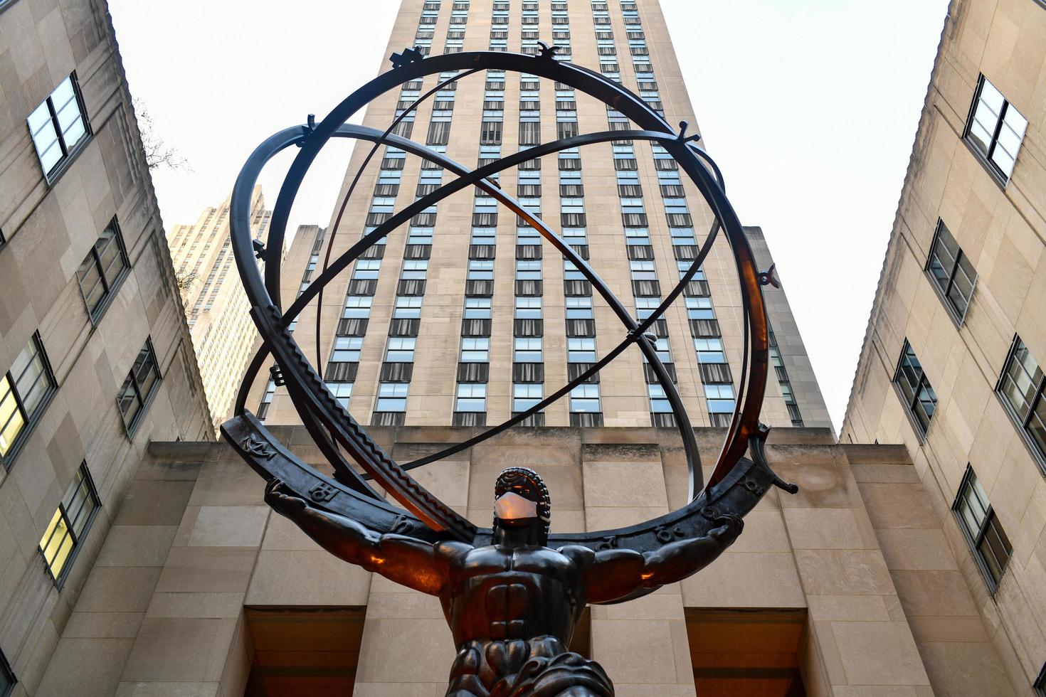 New York, NY - Nov 14, 2020 -  Real estate firm Tishman Speyer fitted masks on Atlas and other classic statues in Rockefeller Center to encourage New Yorkers to wear COVID-19 face coverings. photo