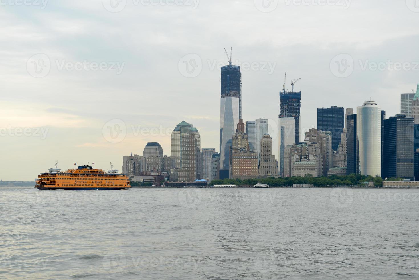 Staten Island Ferry crossing the New York City skyline from Governor's Island. photo
