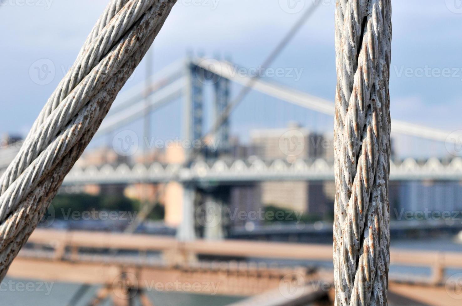 View of the NYC Skyline and the Manhattan Bridge from the Brooklyn Bridge in the summer. photo