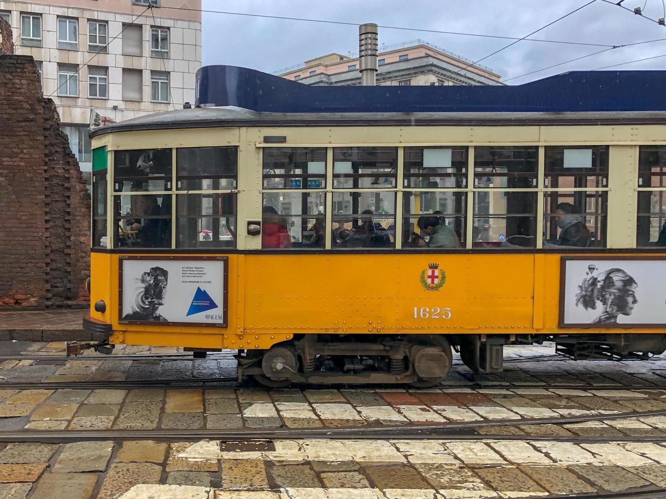 Milan, Italy - March 18, 2018 -  Street car travelling through the streets of Milan, Italy on a cloudy day. photo