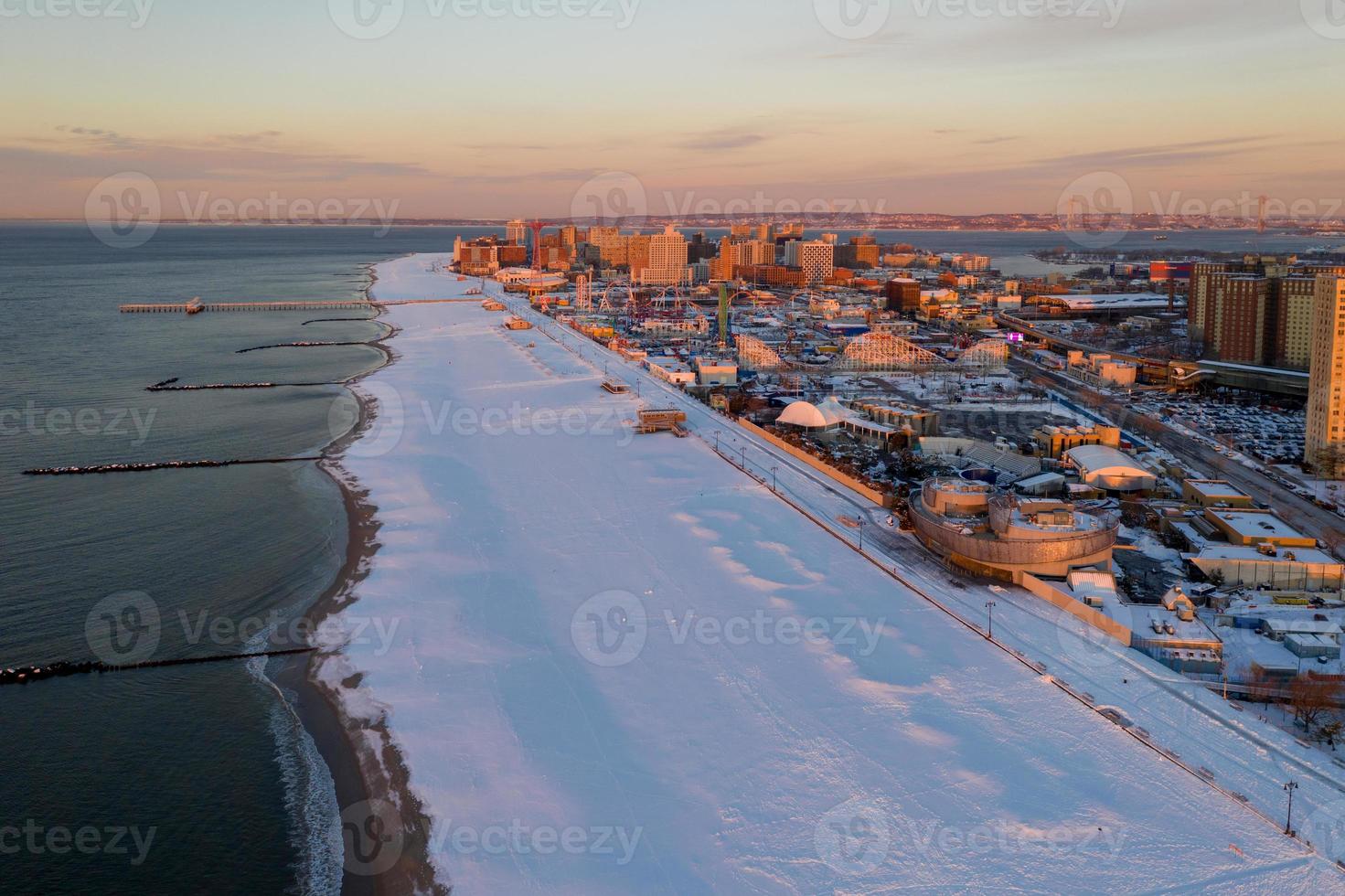 Aerial view of a snow covered Coney Island Beach during the winter at sunrise in Brooklyn, New York photo