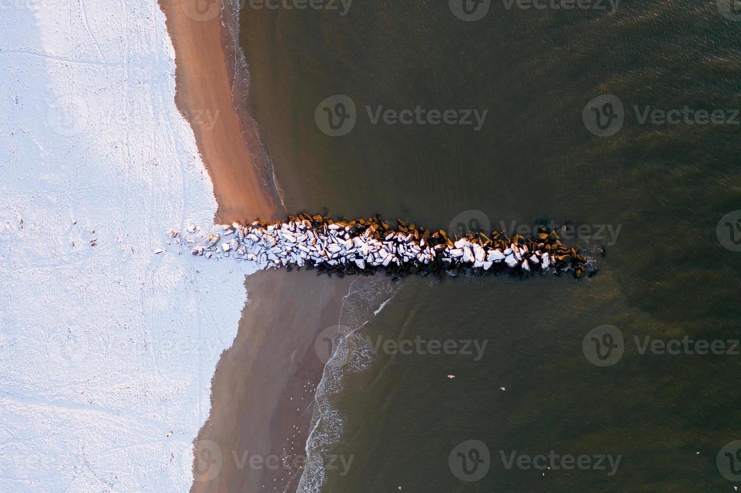 Aerial view of a snow covered Coney Island Beach during the winter at sunrise in Brooklyn, New York photo