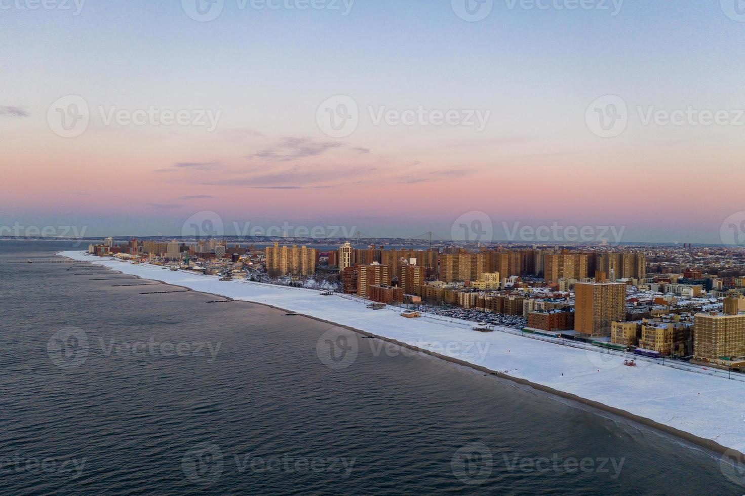 Aerial view of a snow covered Coney Island Beach during the winter at sunrise in Brooklyn, New York photo