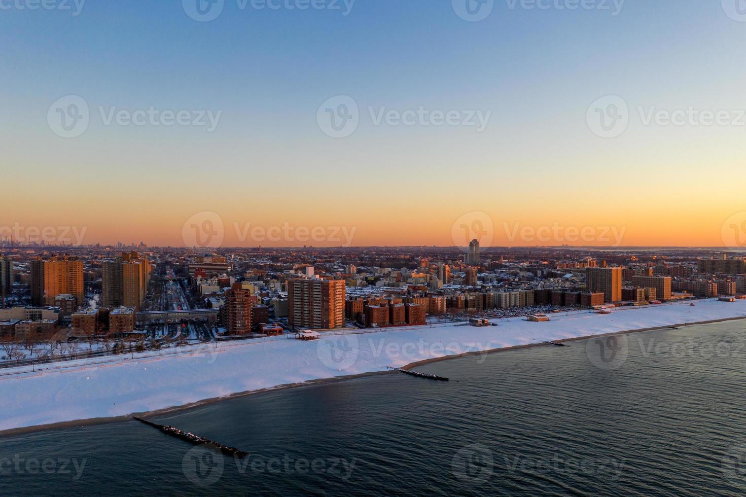 Aerial view of a snow covered Coney Island Beach during the winter at sunrise in Brooklyn, New York photo