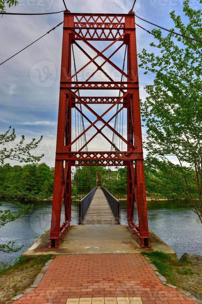 The Androscoggin Swinging Bridge is a pedestrian suspension bridge spanning the Androscoggin River between the Topsham Heights neighborhood of Topsham, Maine and neighboring Brunswick. photo