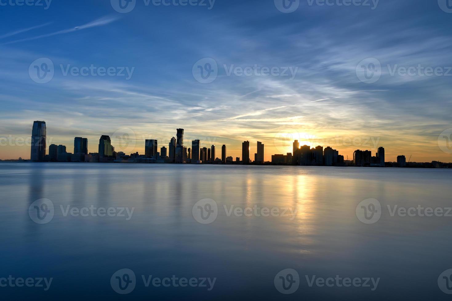 New Jersey skyline at sunset from Manhattan, New York City over the Hudson River. photo