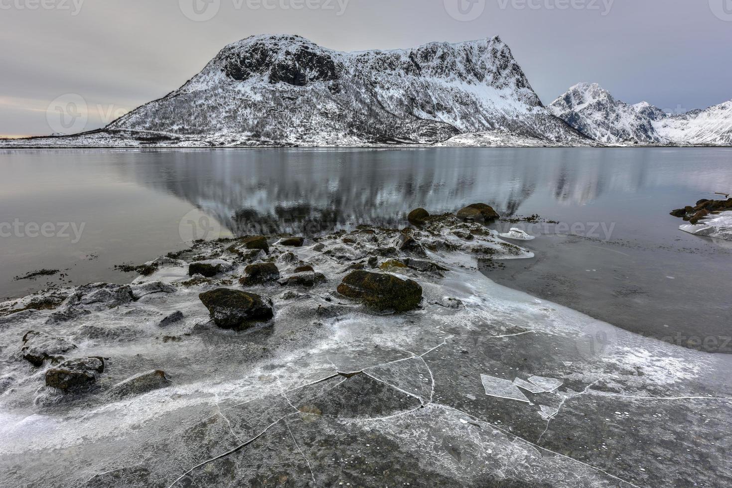 Vagspollen reflection at sunrise in the Lofoten Islands, Norway in the winter. photo