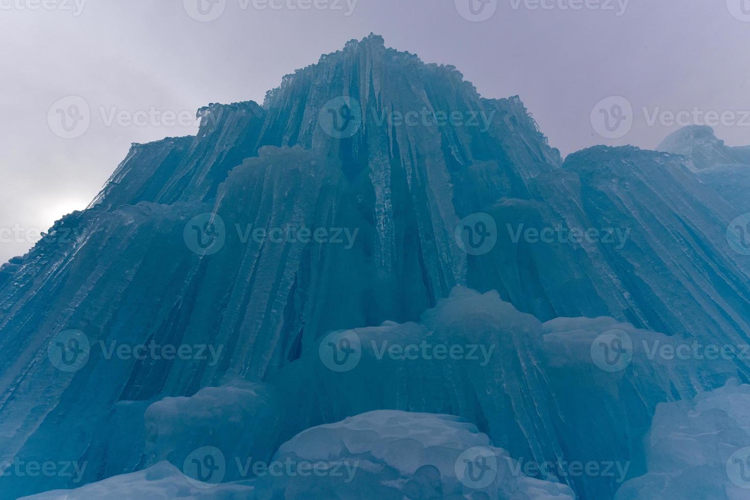 Translucent blue icicles in a frozen ice wall. photo