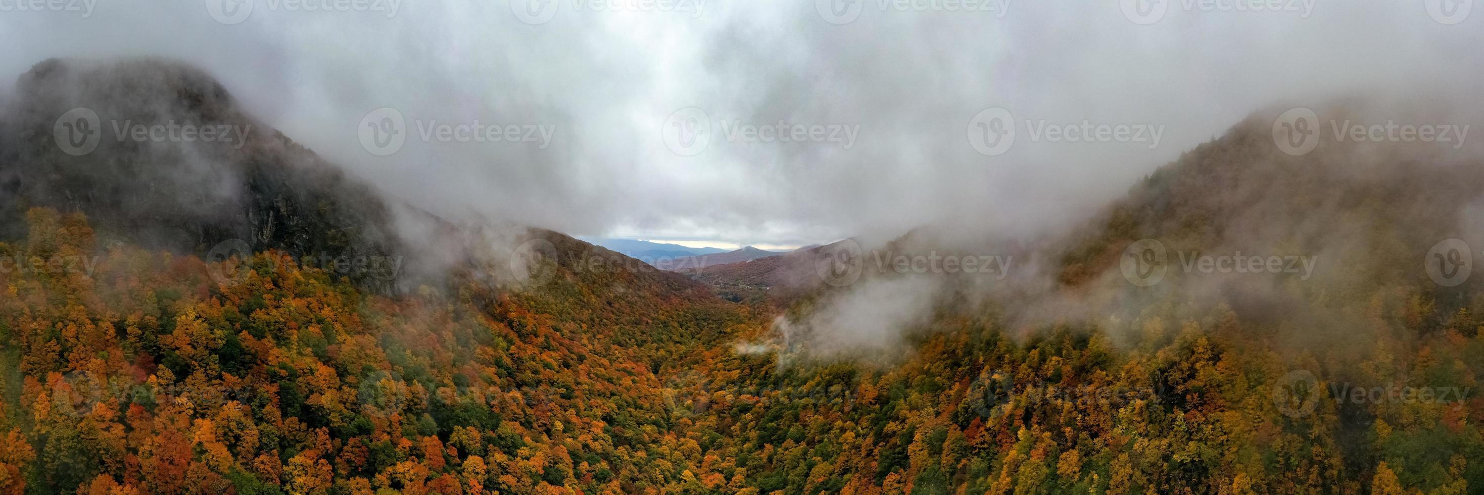 Panoramic view of peak fall foliage in Smugglers Notch, Vermont. photo