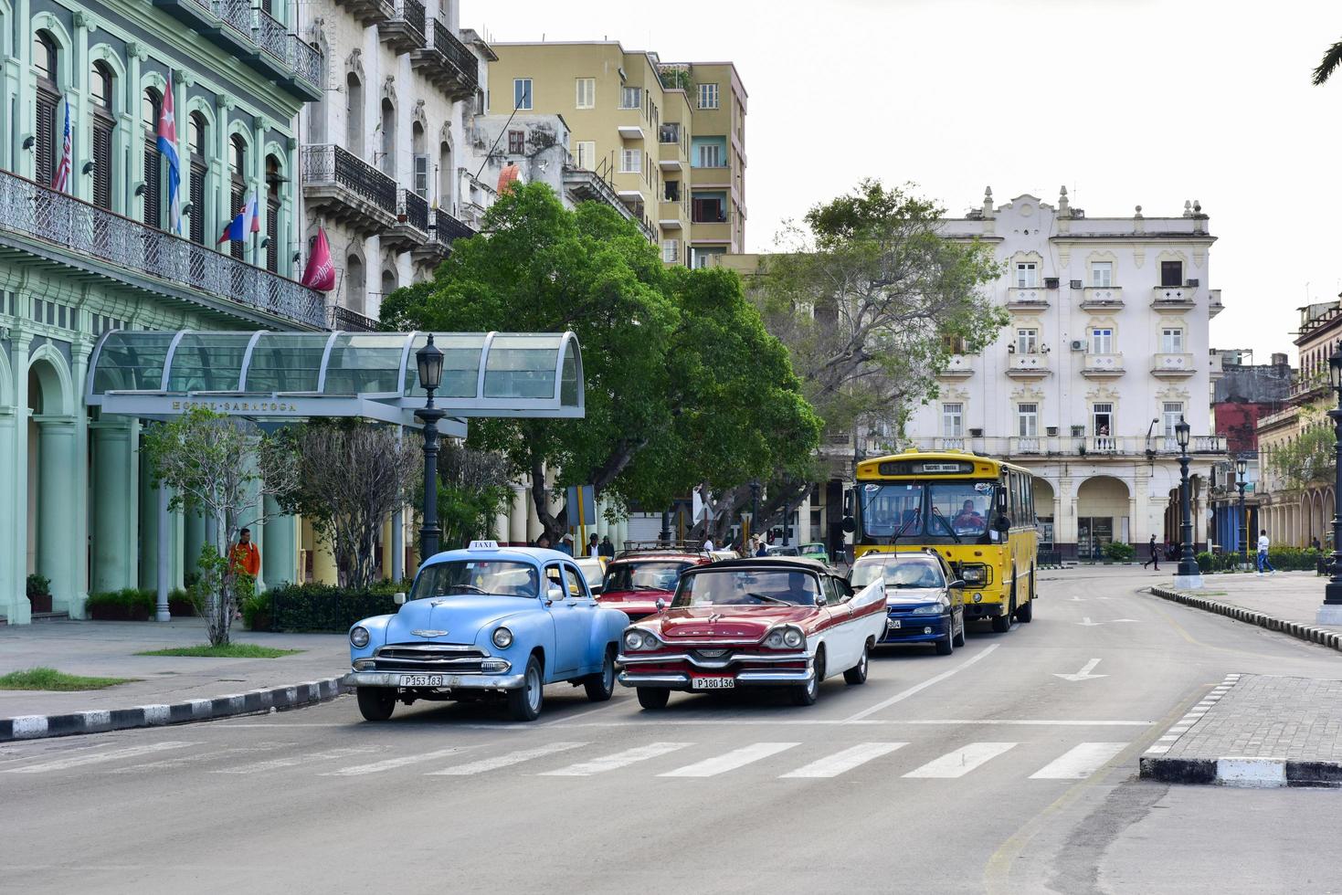 Havana, Cuba - January 7, 2016 -  Classic cars driving along the wide boulevard Paseo del Prad in Havana, Cuba. photo