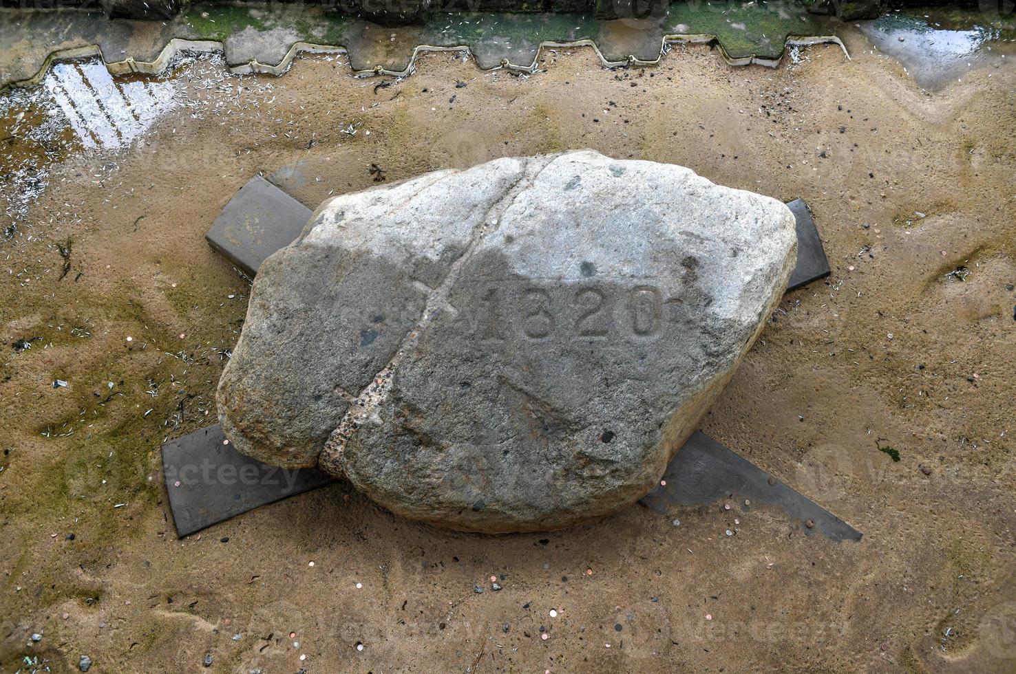 The famous Plymouth Rock, the traditional site of disembarkation of the Mayflower pilgrims in the New World. photo