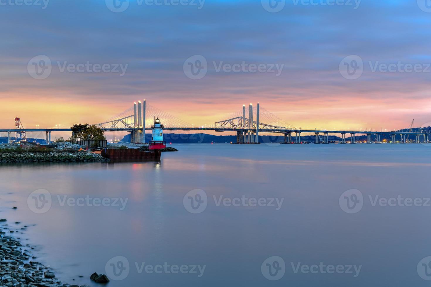 New and Old Tappan Zee Bridges coexisting across Hudson River with a dramatic sunset. photo