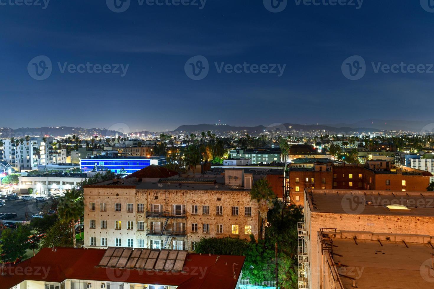 Aerial view of the Los Angeles skyline at night looking towards Hollywood Hills in California. photo