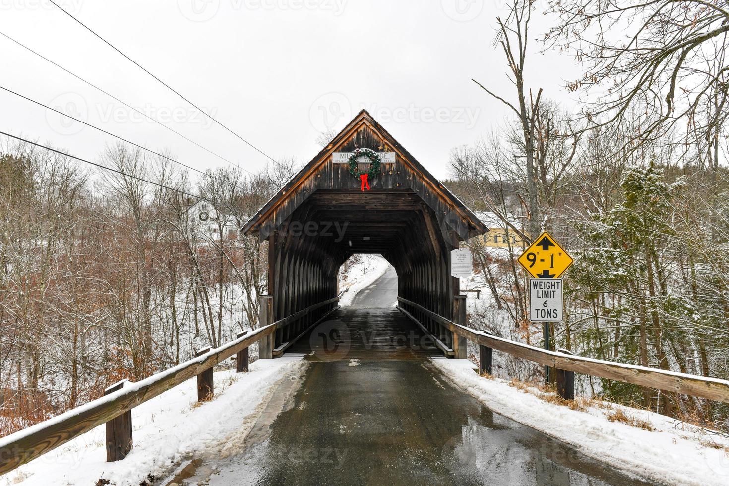 Meriden Covered Bridge over Blood Brook in New Hampshire during the winter. photo