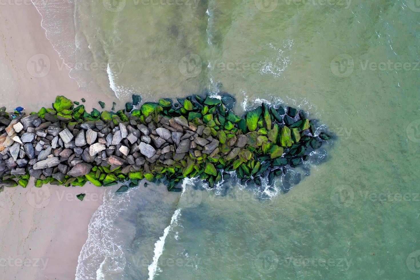 Rocky outpost on Coney Island beach in Brooklyn, New York photo