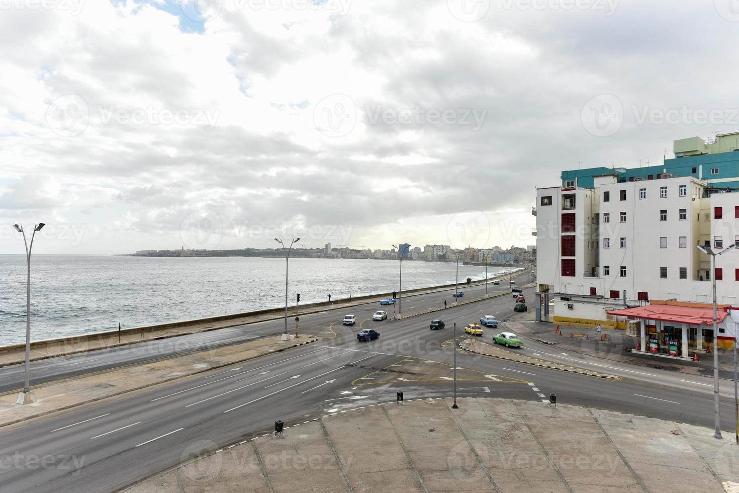 The Malecon in Havana. It is a broad esplanade, roadway and seawall which stretches for 8 km along the coast in Havana, Cuba. photo