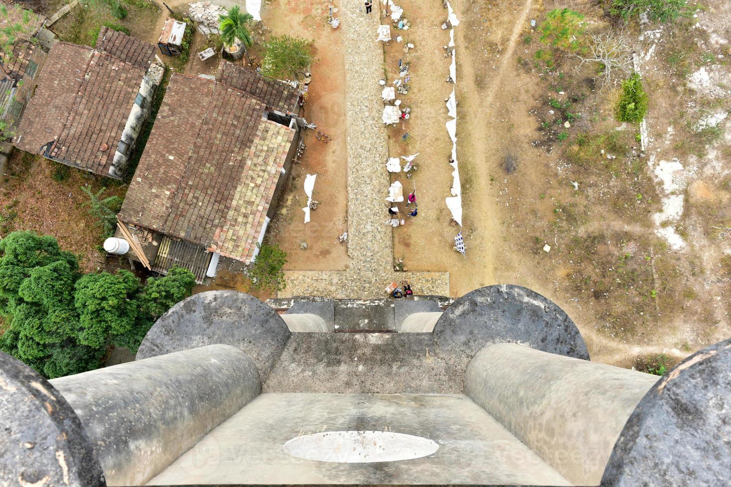 Historic slave watch tower in Manaca Iznaga, Valle de los Ingenios, Trinidad, Cuba. The Manaca Iznaga Tower is the tallest lookout tower ever built in the Caribbean sugar region. photo