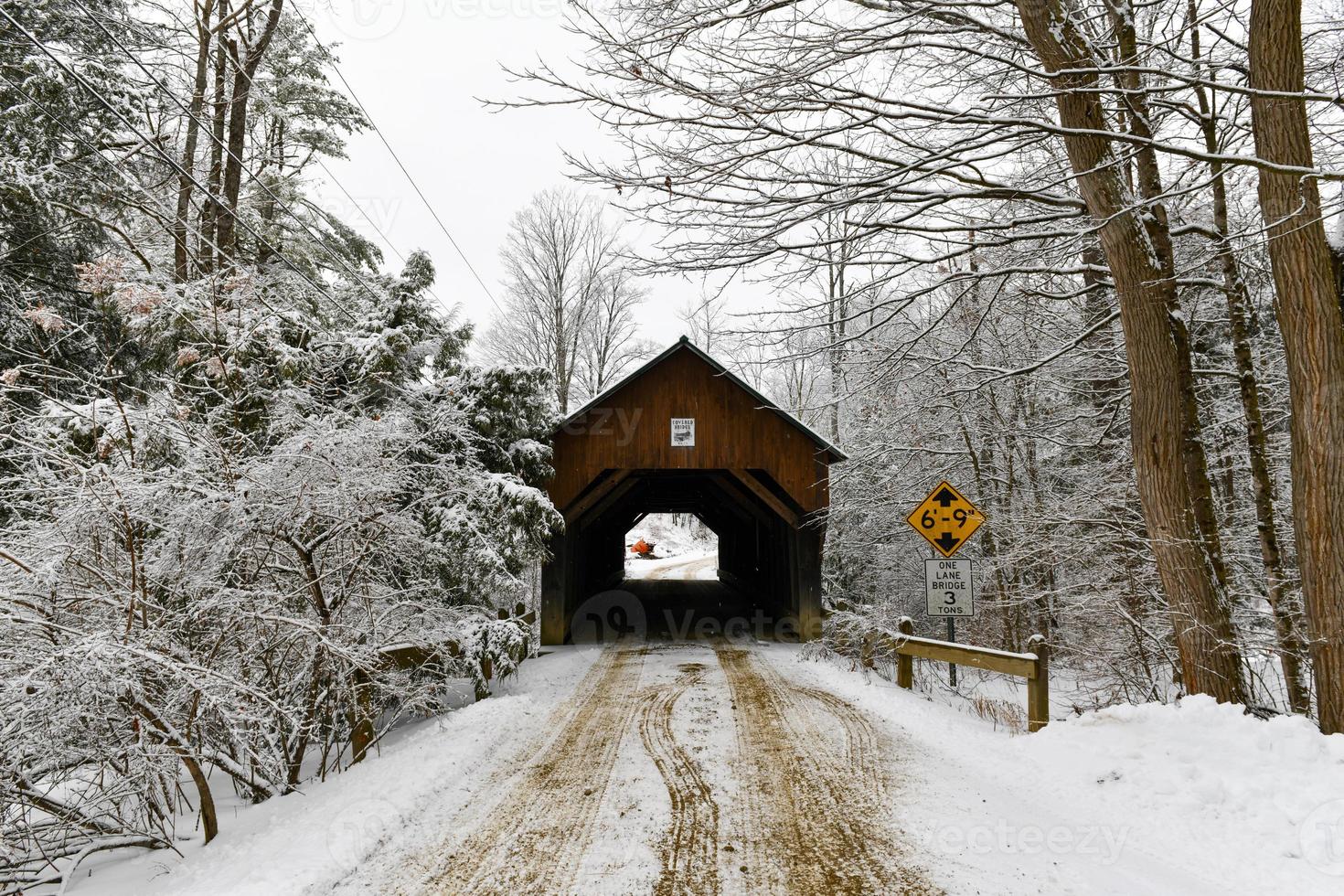 Blow-Me-Down Covered Bridge in Plainfield, New Hampshire during the winter. photo