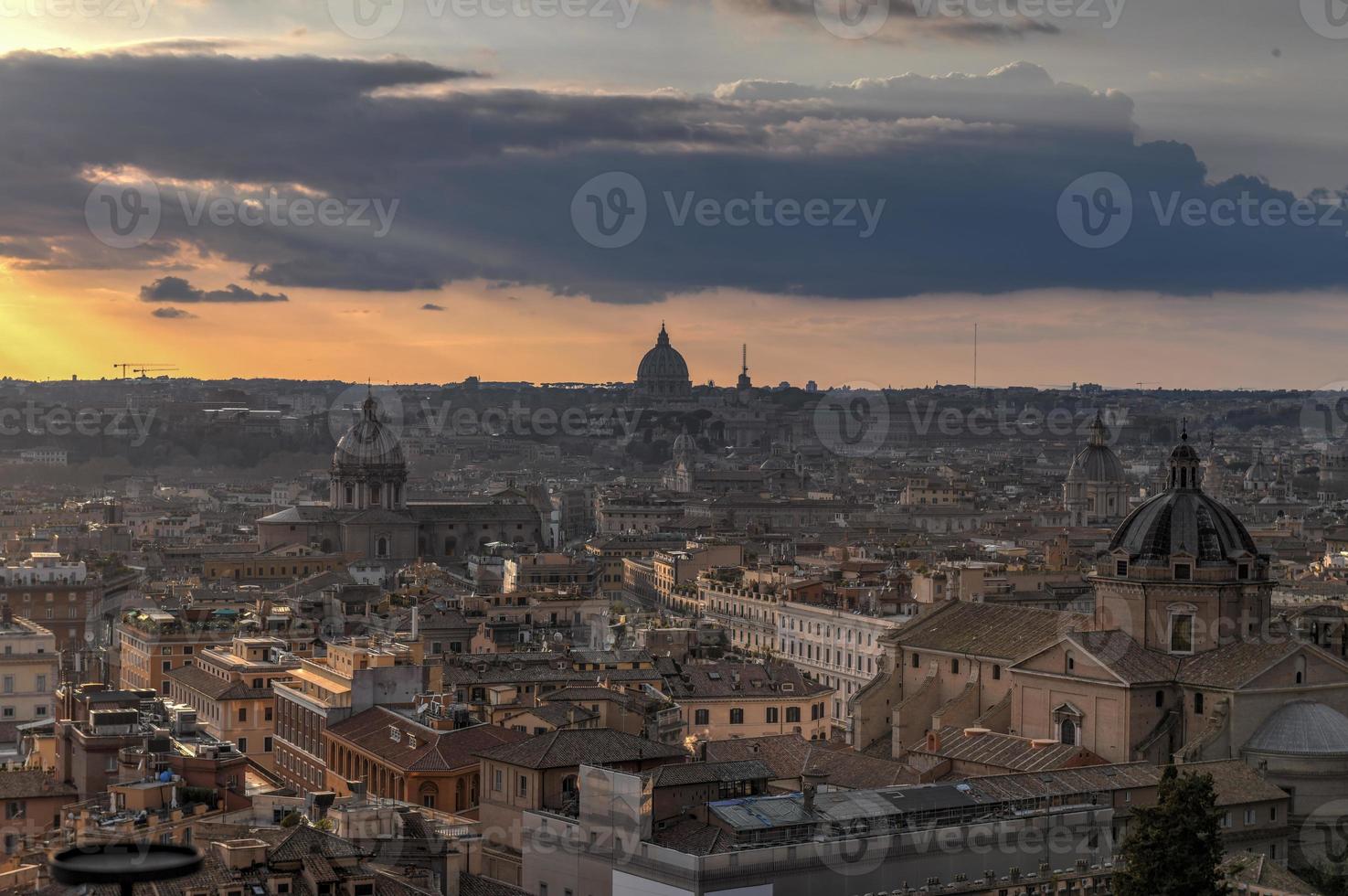 Aerial view of the skyline of Rome, Italy as sunset approaches. photo